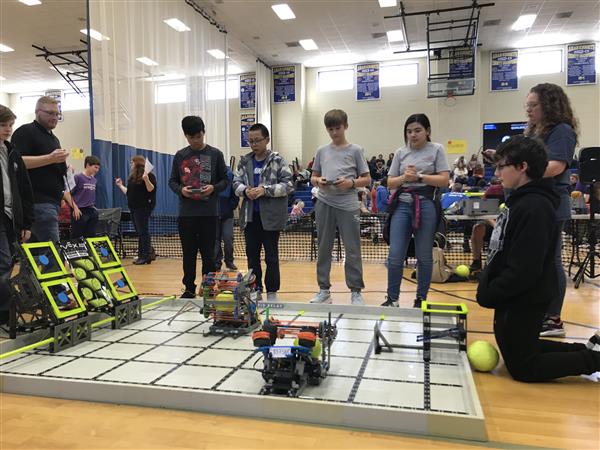 Students control their robots at a VEX IQ Robotics competition.